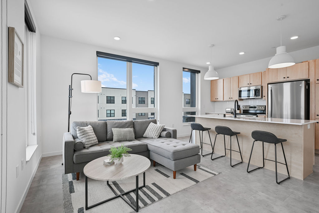 The Common Place furnished living room and kitchen